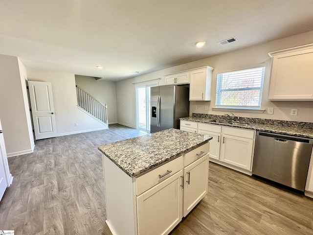 kitchen with plenty of natural light, visible vents, stainless steel appliances, and a sink