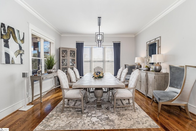 dining space featuring crown molding, baseboards, and dark wood-type flooring