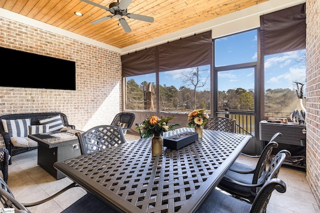 sunroom with wooden ceiling and a ceiling fan