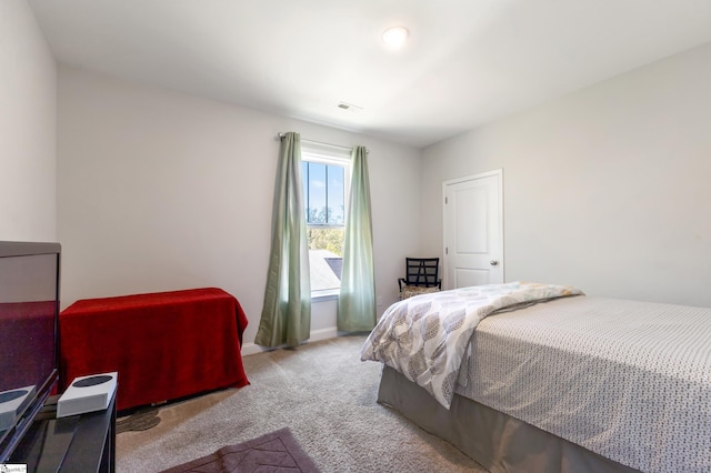 bedroom with carpet, visible vents, and baseboards