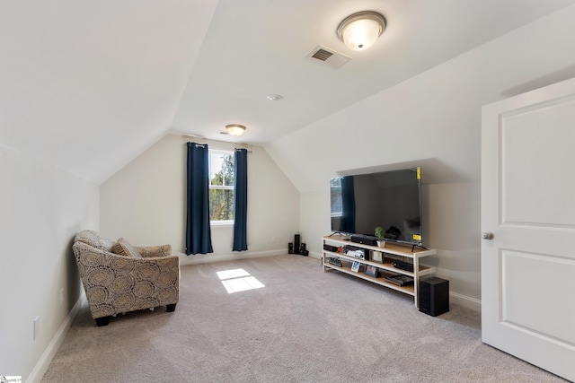 sitting room featuring carpet floors, baseboards, visible vents, and vaulted ceiling