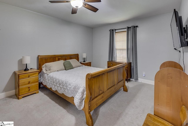 bedroom with light carpet, ceiling fan, and baseboards