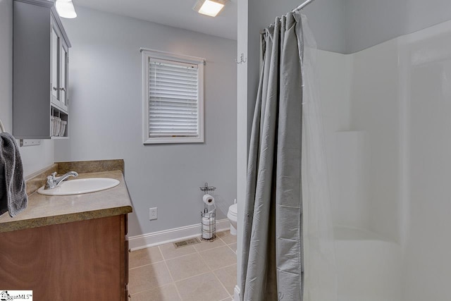 bathroom with visible vents, baseboards, toilet, tile patterned flooring, and vanity