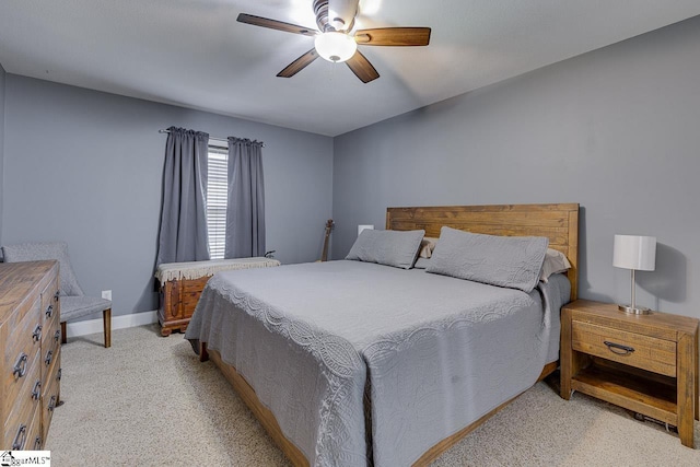 bedroom featuring a ceiling fan, light colored carpet, and baseboards