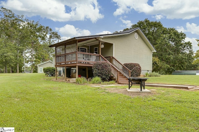 back of house featuring crawl space, stairway, a deck, and a yard