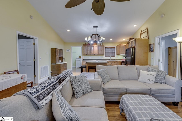 living room with recessed lighting, visible vents, light wood finished floors, and ceiling fan with notable chandelier