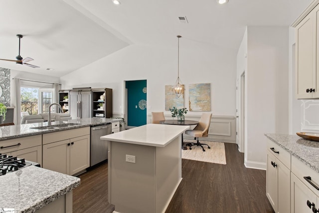 kitchen featuring dark wood-type flooring, visible vents, a sink, and stainless steel dishwasher