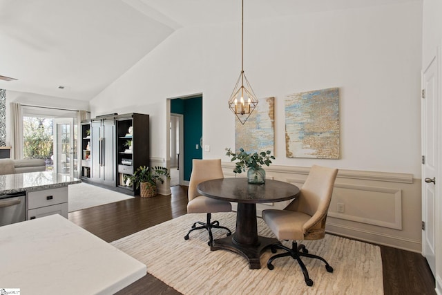 dining area with a chandelier, high vaulted ceiling, baseboards, and wood finished floors