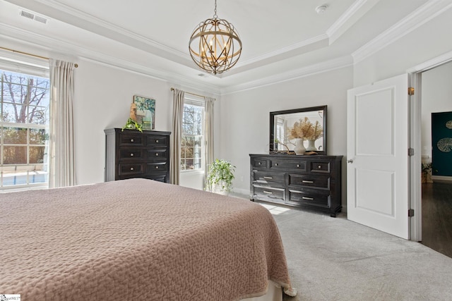 bedroom with carpet, a raised ceiling, multiple windows, and visible vents