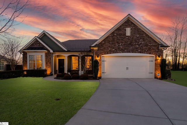 view of front facade with an attached garage, driveway, brick siding, and a front yard