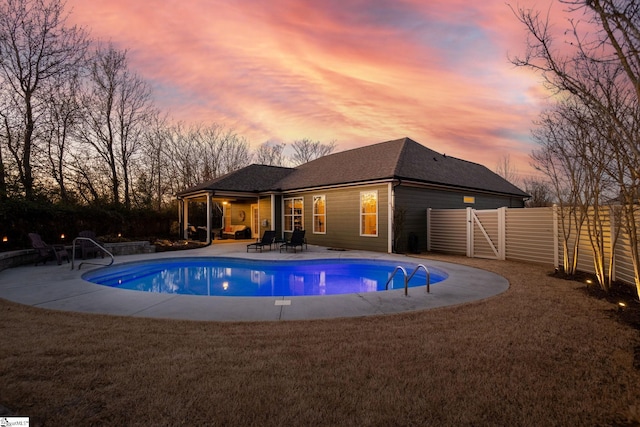 view of pool featuring a patio area, a fenced in pool, fence, and a lawn