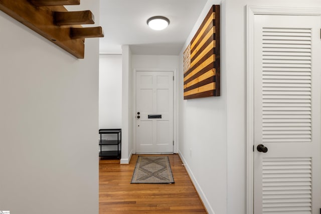 entryway with baseboards and wood finished floors