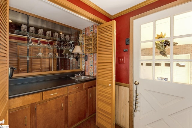 bar featuring crown molding and a sink