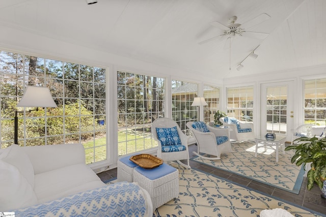 sunroom with rail lighting, ceiling fan, and vaulted ceiling