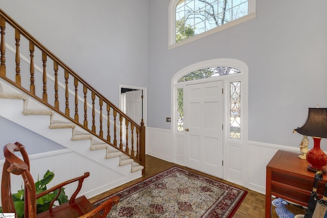 entrance foyer with wainscoting and stairs