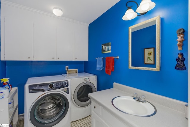 clothes washing area with light tile patterned floors, crown molding, a sink, and washer and dryer