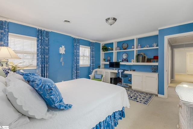 carpeted bedroom featuring crown molding, attic access, visible vents, and built in desk