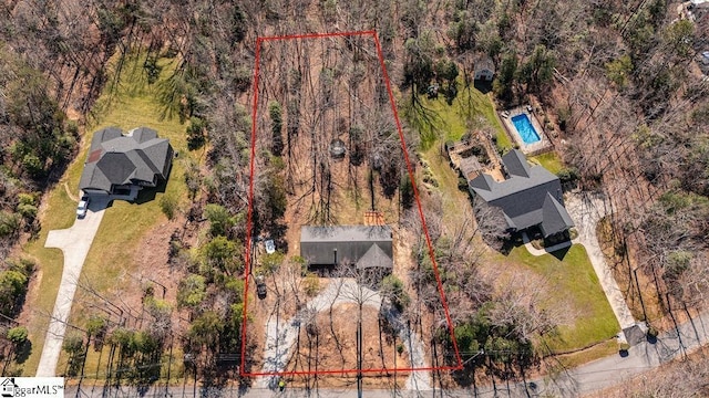 birds eye view of property with a forest view