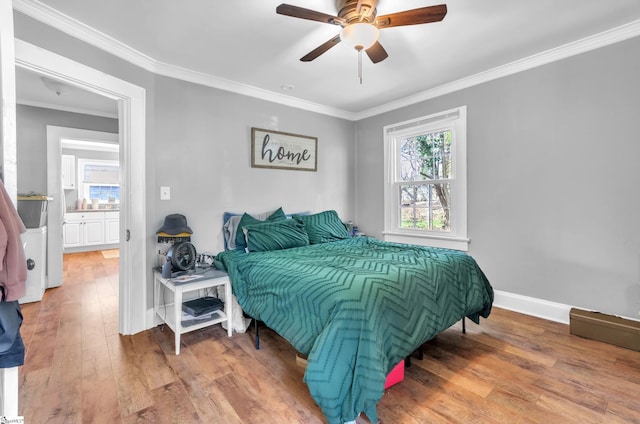 bedroom featuring ornamental molding, ceiling fan, baseboards, and wood finished floors