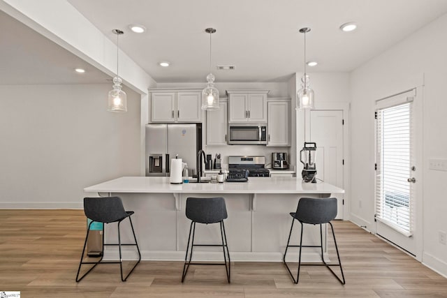 108 Marston Ln, Greenville, SC 29617 - kitchen with stainless steel appliances, visible vents, a center island with sink, and a kitchen breakfast bar