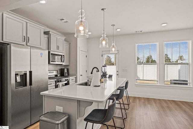 108 Marston Ln, Greenville, SC 29617 - kitchen with stainless steel appliances, a sink, visible vents, light countertops, and light wood-type flooring