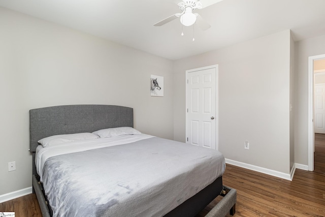 bedroom featuring ceiling fan, wood finished floors, and baseboards