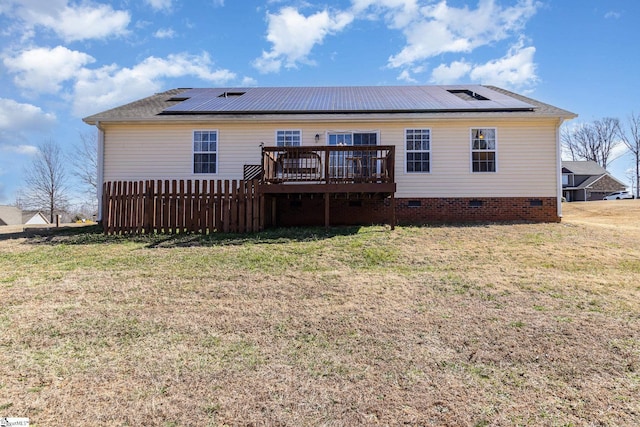 rear view of house featuring a deck, a yard, and crawl space