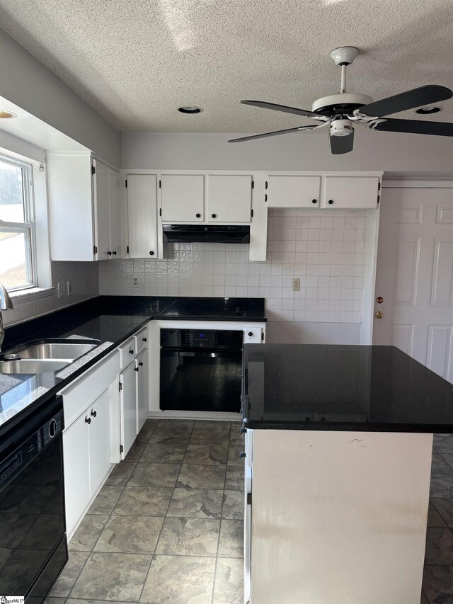 144 Amber Dr, Inman, SC 29349 - kitchen with dark countertops, a sink, under cabinet range hood, black appliances, and backsplash