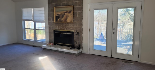 144 Amber Dr, Inman, SC 29349 - unfurnished living room featuring french doors, a fireplace, carpet flooring, and visible vents