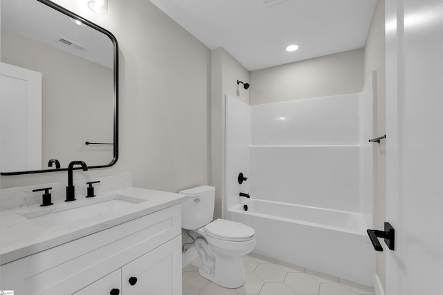 bathroom featuring toilet, vanity, visible vents,  shower combination, and tile patterned floors