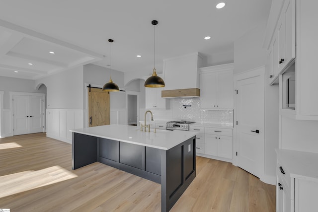 794 Hebron Church Rd, Iva, SC 29655 - kitchen featuring premium range hood, a barn door, gas range, and white cabinetry