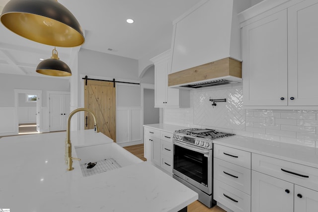 794 Hebron Church Rd, Iva, SC 29655 - kitchen with a barn door, white cabinets, a sink, gas range, and premium range hood