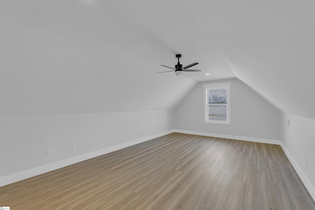 bonus room featuring vaulted ceiling, ceiling fan, light wood finished floors, and baseboards