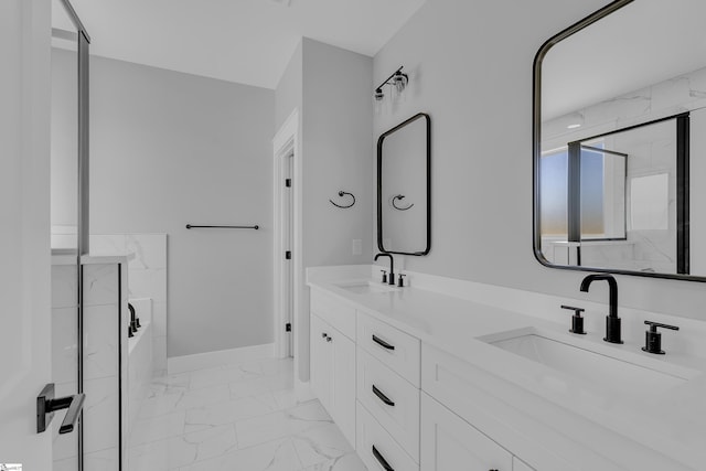 bathroom with a bath, marble finish floor, baseboards, and a sink