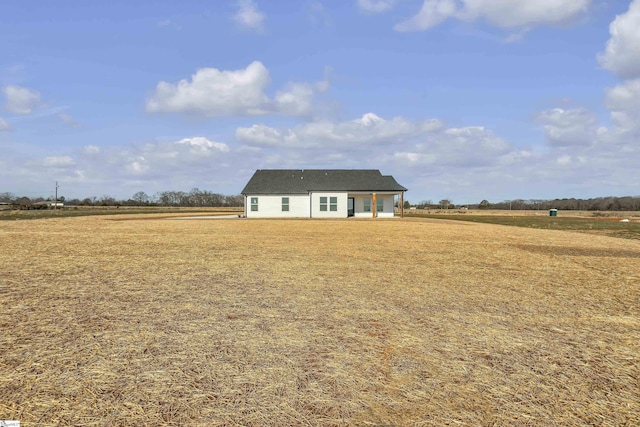 view of front facade with a rural view and a front yard