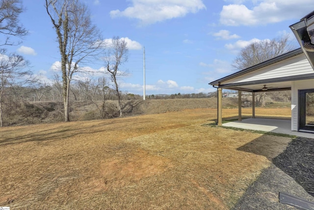 view of yard with a ceiling fan and a patio