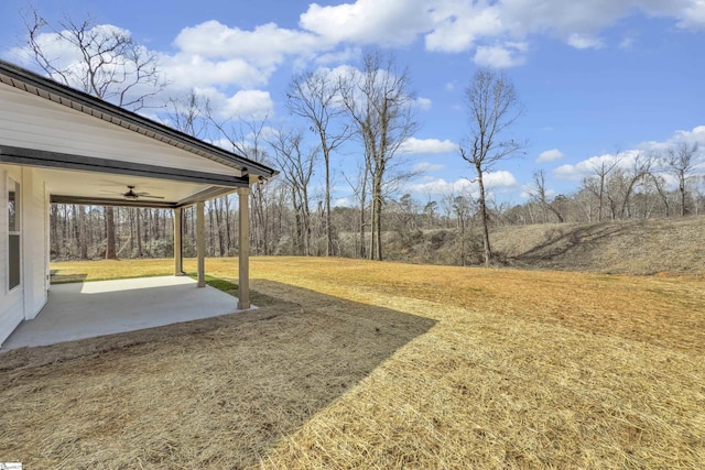 view of yard featuring a patio area and a ceiling fan