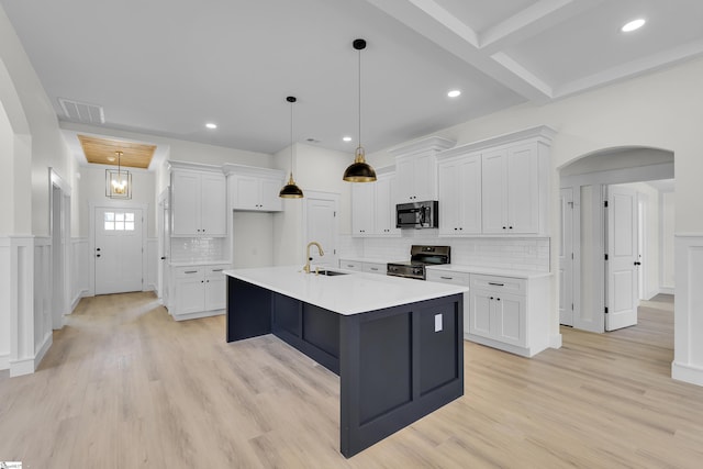 kitchen featuring arched walkways, light countertops, stainless steel electric range, and white cabinets