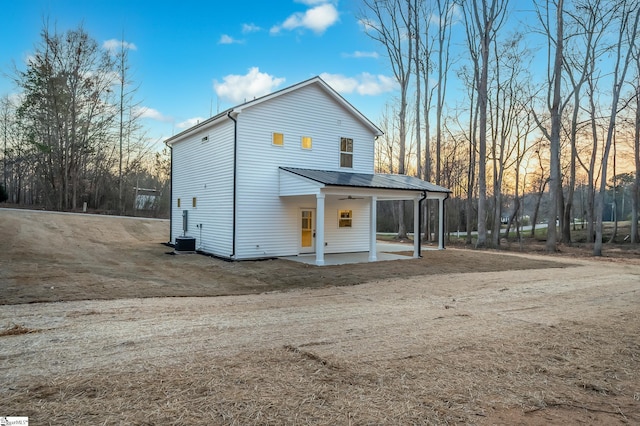 view of front of house with metal roof, a patio, and a ceiling fan