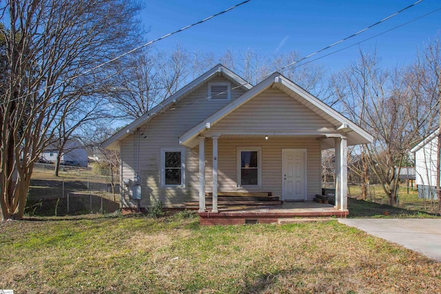 bungalow-style home featuring a front lawn, fence, and a porch