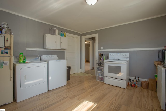 laundry area with laundry area, ornamental molding, light wood-style flooring, and washer and dryer