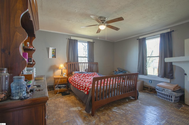 bedroom featuring a textured ceiling, ceiling fan, and crown molding