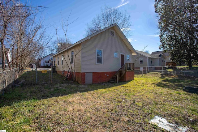 back of property with a fenced backyard and a yard