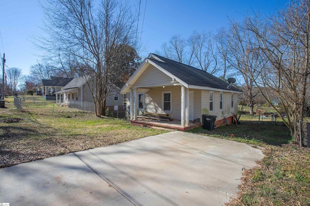 view of front of home with a porch and fence