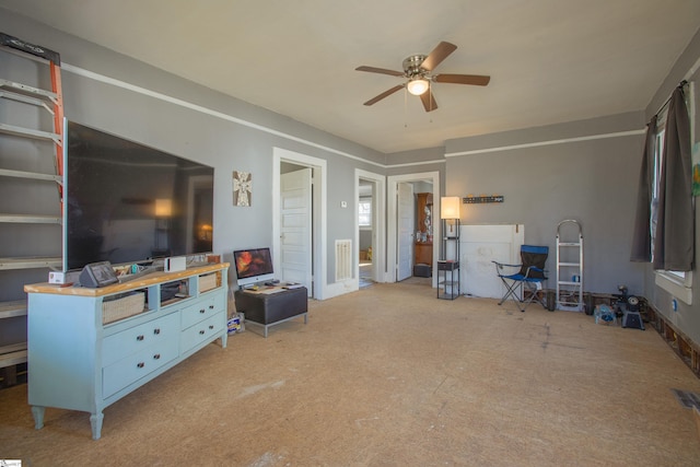 living room featuring carpet floors and a ceiling fan