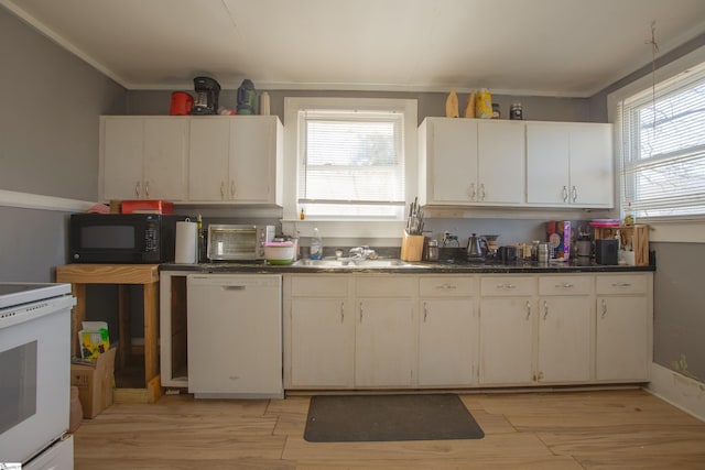 kitchen with electric stove, white dishwasher, a sink, light wood-type flooring, and black microwave