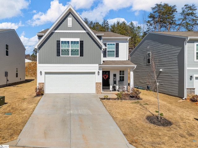 craftsman house with a garage, a front lawn, concrete driveway, and brick siding