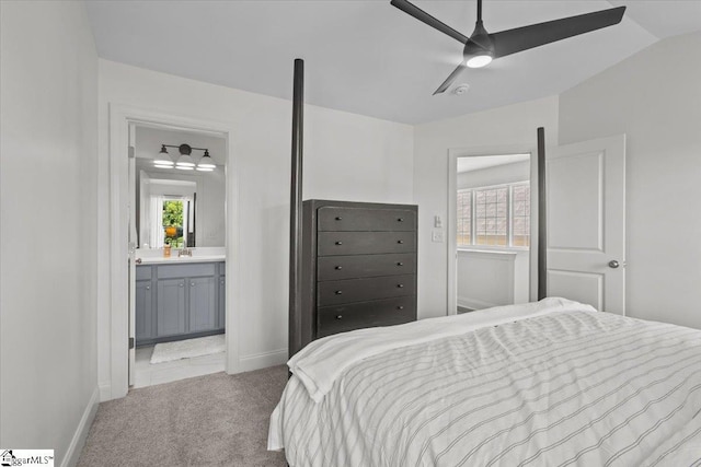 bedroom with ensuite bathroom, carpet, a ceiling fan, and baseboards