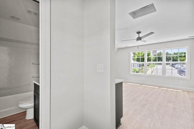 full bathroom featuring visible vents, toilet, a ceiling fan, wood finished floors, and baseboards