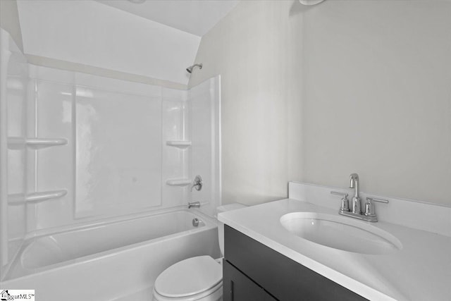 bathroom featuring tub / shower combination, vanity, and toilet